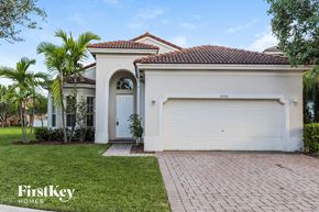 Homestead house for rent - a white house with a white garage door and a lawn