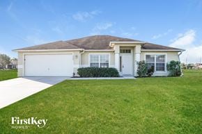 Cape Coral house for rent - a white house with a lawn in front of it