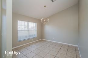 Cape Coral house for rent - a dining room with a large window and a tiled floor