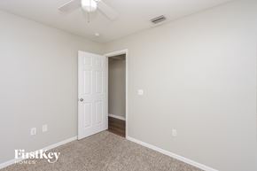 Brandon house for rent - a bedroom with a white door and a ceiling fan