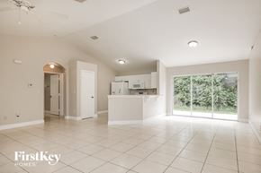 Lehigh Acres house for rent - an empty living room and kitchen with a large window
