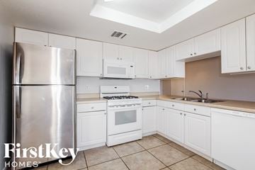 Phoenix house for rent - A kitchen with white cabinets and appliances.