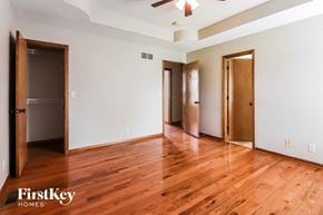 Raymore house for rent - a living room with a hard wood floor and three doors
