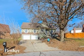 Independence house for rent - a house with a driveway and a tree in front of it