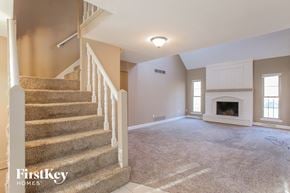 Independence house for rent - an empty living room with a staircase and a fireplace