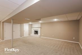 Independence house for rent - a living room with a fireplace and a carpeted floor