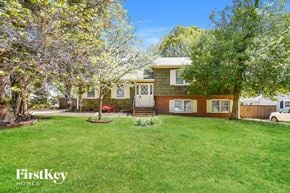 Greensboro house for rent - A house with a green lawn and trees in the front yard.