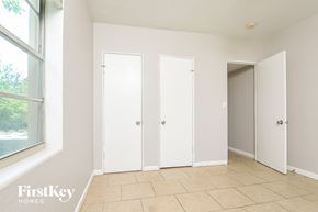 Winter Haven house for rent - a bedroom with three closet doors and a window