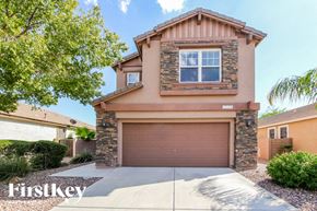 Surprise house for rent - A house with a brown garage door is for sale.