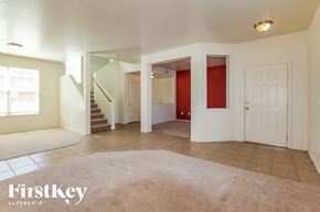 Surprise house for rent - A spacious living room with a staircase leading to the upper floor.