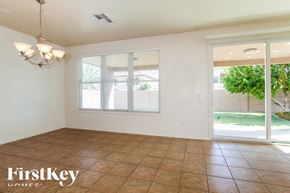 Surprise house for rent - A room with a tiled floor and a chandelier.