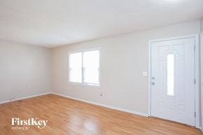 Excelsior Springs house for rent - a bedroom with white walls and wood floors and a white door