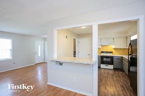 Excelsior Springs house for rent - a living room with a kitchen with a counter top
