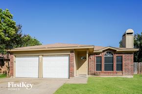 Arlington house for rent - A brick house with a garage and a chimney.