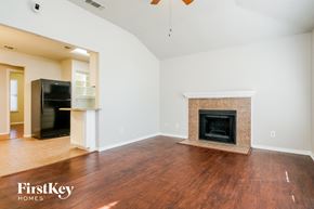 Arlington house for rent - A living room with a fireplace and a television.