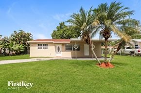 North Lauderdale house for rent - a house with palm trees in front of it