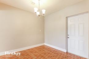 North Lauderdale house for rent - a living room with a white door and a wooden floor