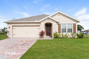Cape Coral house for rent - A house with a brown door and a garage door is shown.