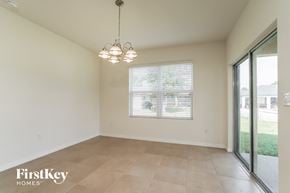 Cape Coral house for rent - A room with a sliding glass door leading to a backyard.