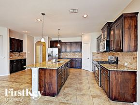 Argyle house for rent - a kitchen with wooden cabinets and a counter top