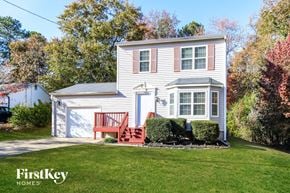 Loganville house for rent - a white house with a red porch and a lawn