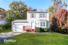 Loganville house for rent - a white house with a red front porch and a lawn