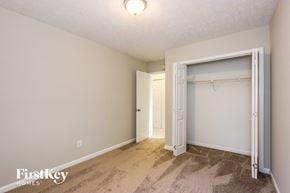 Loganville house for rent - a bedroom with a closet and a door to a bathroom