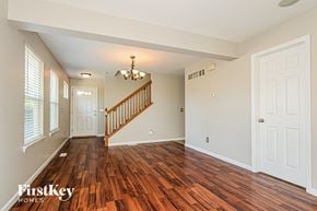 Saint Peters house for rent - A room with wooden floors and a staircase.