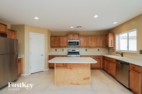 San Tan Valley house for rent - a kitchen with wooden cabinets and a white counter top
