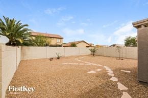 San Tan Valley house for rent - a pathway leading to the backyard of a house with palm trees