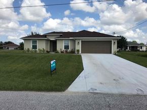 Cape Coral house for rent - a house with a driveway in front of it