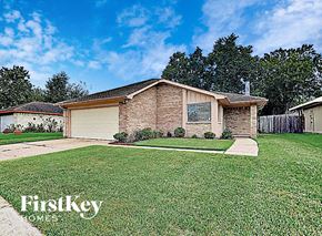 Houston house for rent - a small brick house with a lawn in front of it