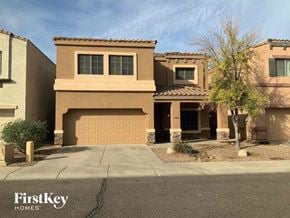 Phoenix house for rent - A house with a brown facade and a garage door is shown.