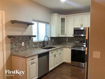 Phoenix house for rent - A kitchen with a stove top oven and a microwave.