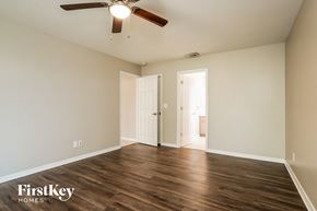 Fort Myers house for rent - the spacious living room with hardwood flooring and a ceiling fan