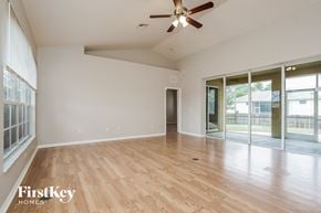 Fort Myers house for rent - A room with a ceiling fan and wooden flooring.
