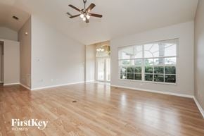 Fort Myers house for rent - A spacious room with wooden flooring and a ceiling fan.