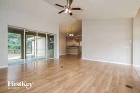 Fort Myers house for rent - A spacious room with wooden flooring and a ceiling fan.