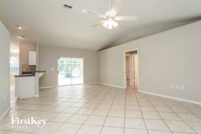 Fort Myers house for rent - A spacious room with a ceiling fan and tiled flooring.