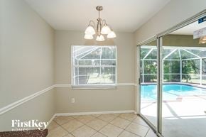 Fort Myers house for rent - A room with a pool visible through the glass door.