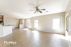 Phoenix house for rent - A spacious room with a ceiling fan and tiled flooring.