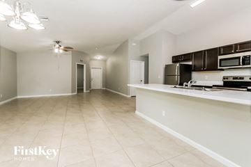 Port St. Lucie house for rent - A kitchen area with a countertop and a microwave.
