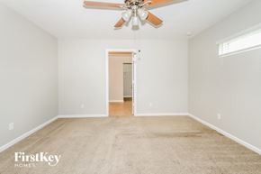 Port St. Lucie house for rent - A spacious room with a carpeted floor and a ceiling fan.