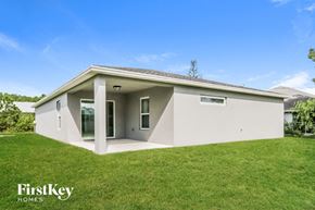 Port St. Lucie house for rent - A modern house with a flat roof and a covered entrance.