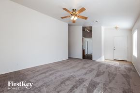 Surprise house for rent - A spacious room with a ceiling fan and carpeted floor.