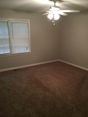 Douglasville house for rent - A room with a ceiling fan and a window with blinds.