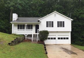 Douglasville house for rent - A white house with a black roof and a chimney.