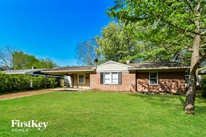 Memphis house for rent - a small brick house with a yard and a tree
