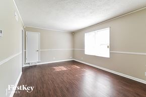 Memphis house for rent - the living room of an empty house with wood floors and a window