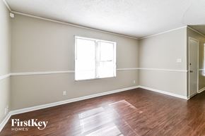 Memphis house for rent - the living room of an empty house with wood floors and a window